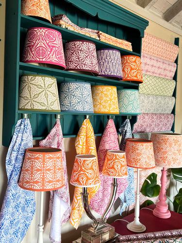 Moji Salehi’s Odyssey Collection of hand-printed home and lifestyle products, including cushions, lampshades, wallpaper, gift wraps, notebooks, and silk scarves, featuring intricate patterns inspired by Persian heritage and contemporary design.